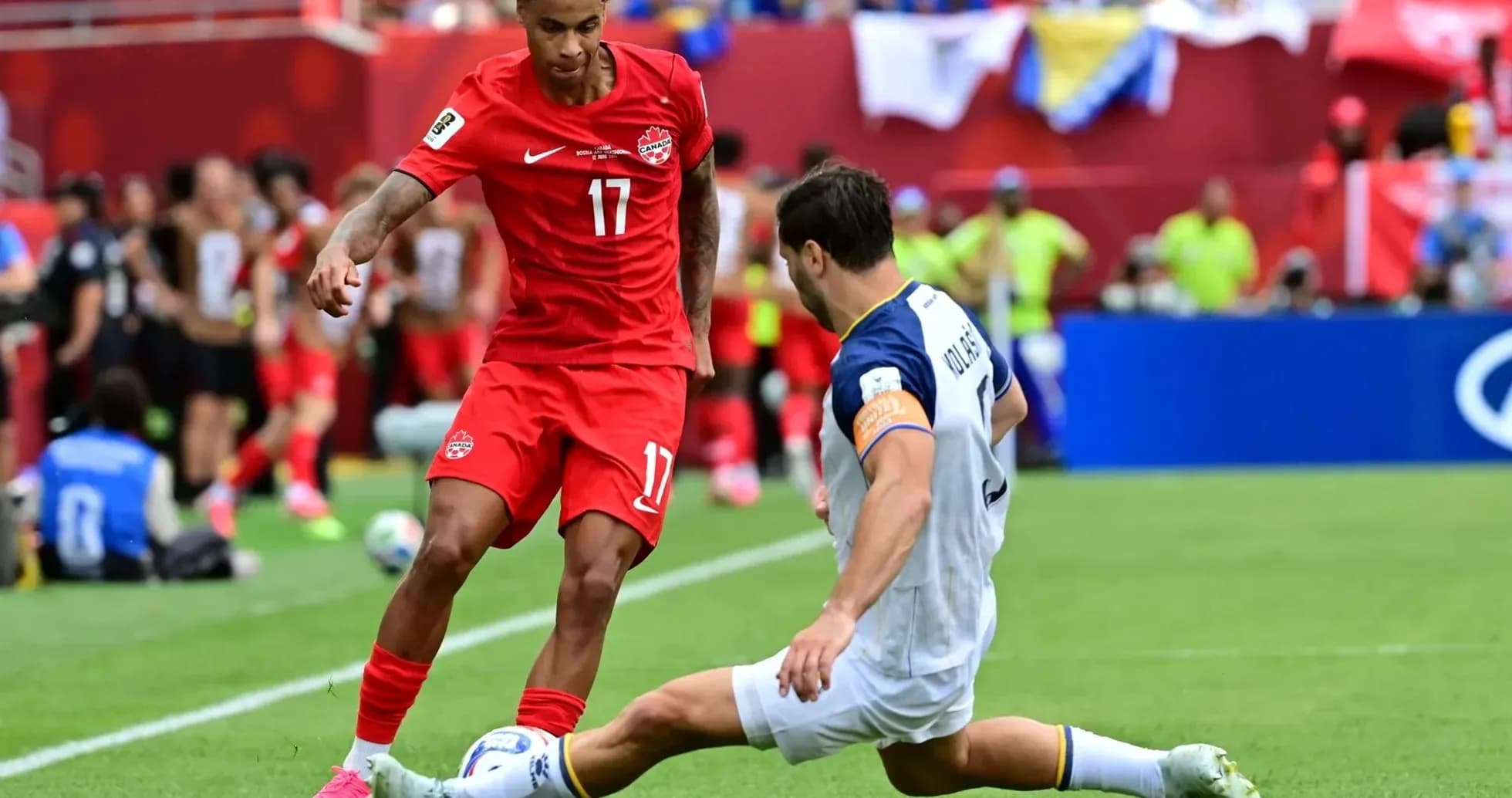 Canada player dribbling past Bosnia defender