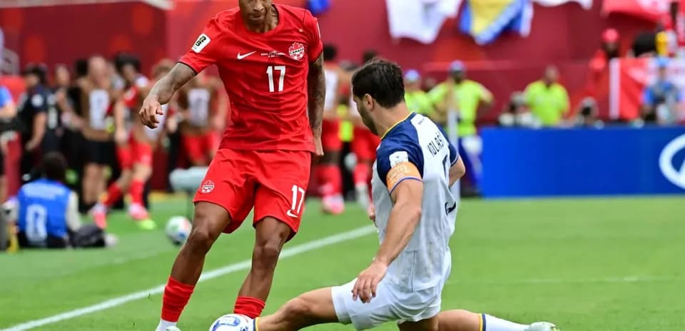 Canada player dribbling past Bosnia defender