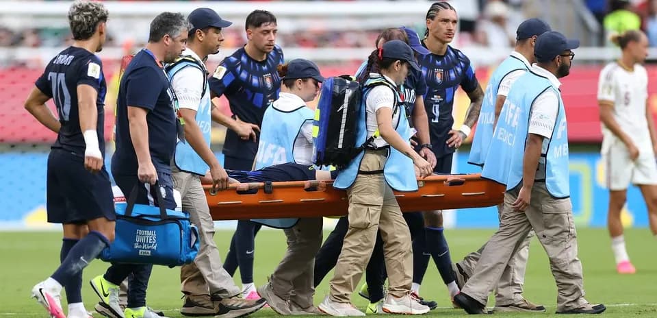 Medical staff carrying injured player on stretcher