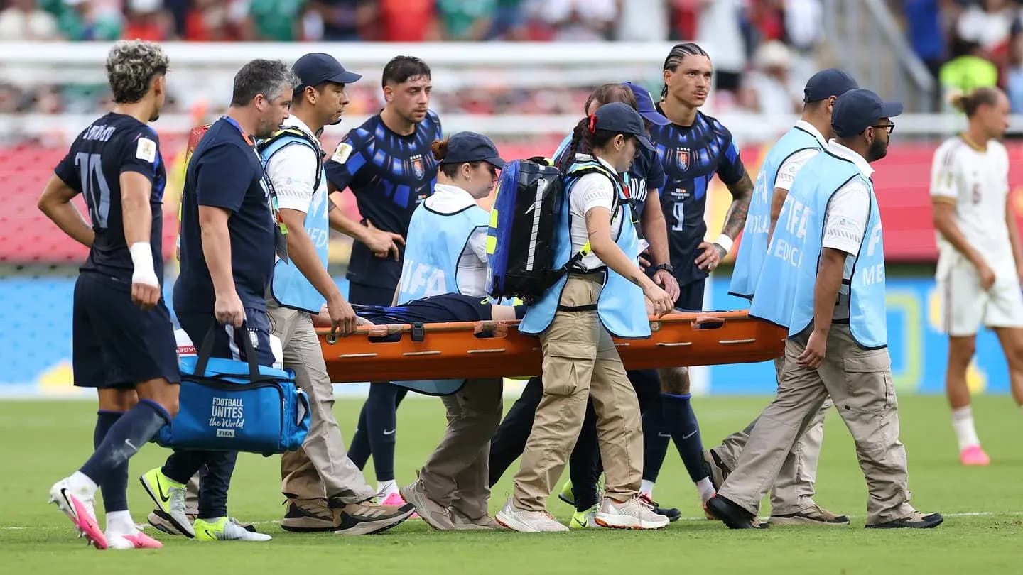 Medical staff carrying injured player on stretcher