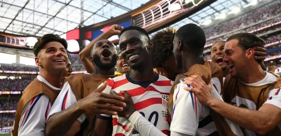 US soccer players celebrating a goal on field