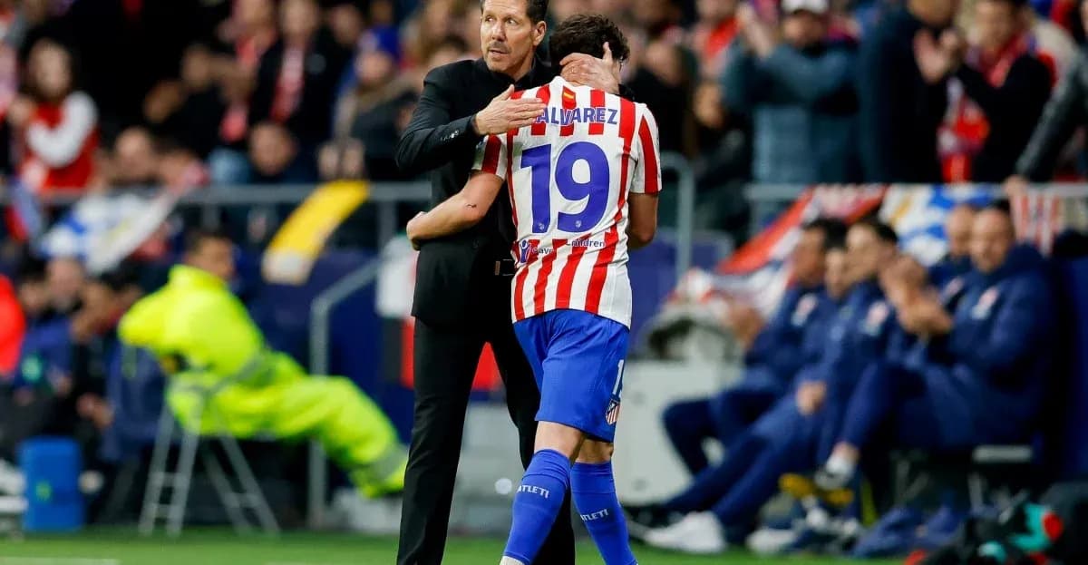 Coach embracing player on the sidelines during match