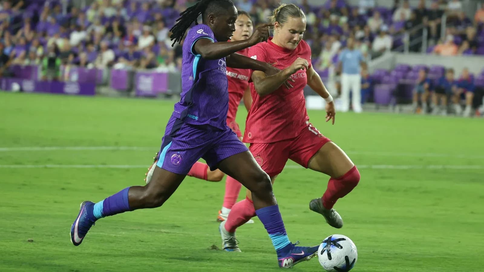 Boston Legacy W player tackling Orlando Pride W player