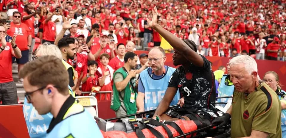 Player on stretcher leaving field amid cheering crowd