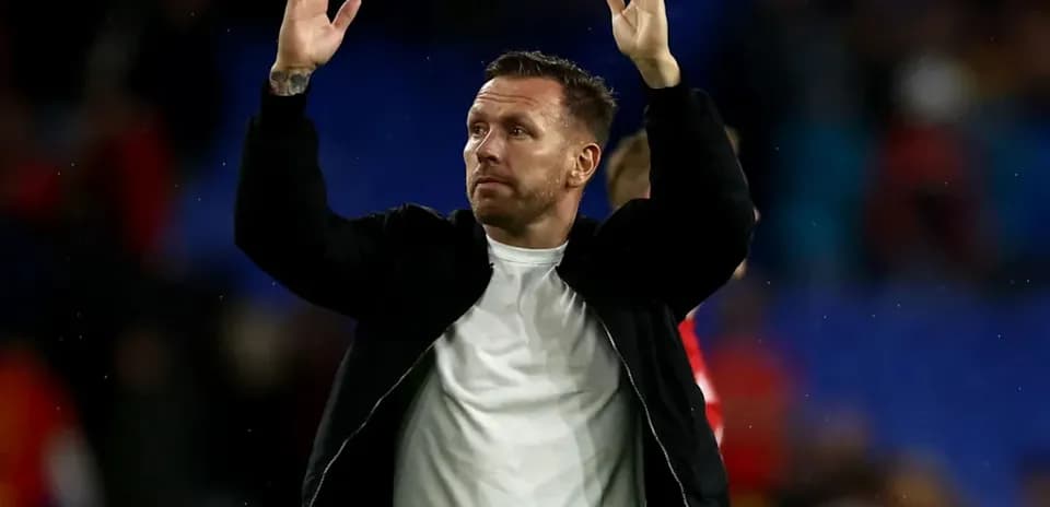 Man gesturing to crowd after a match
