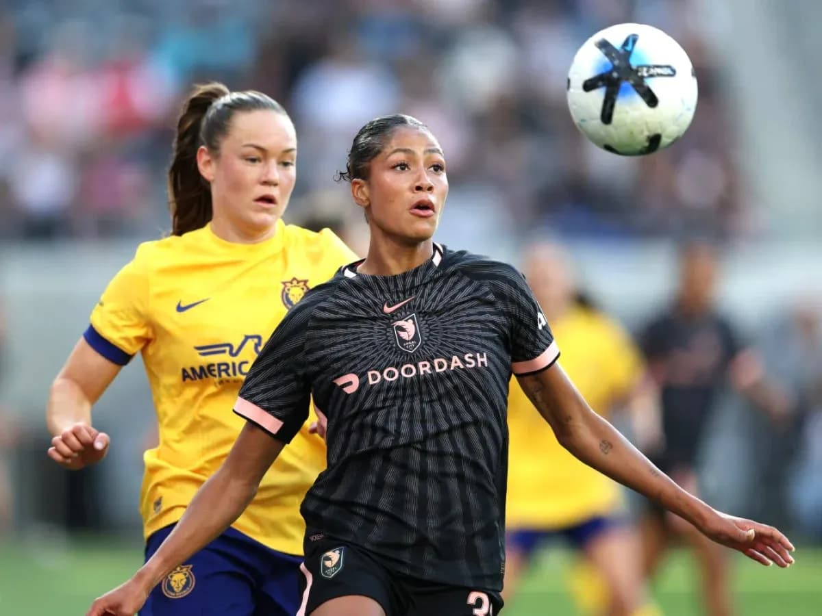 Players competing for the ball in NWSL match