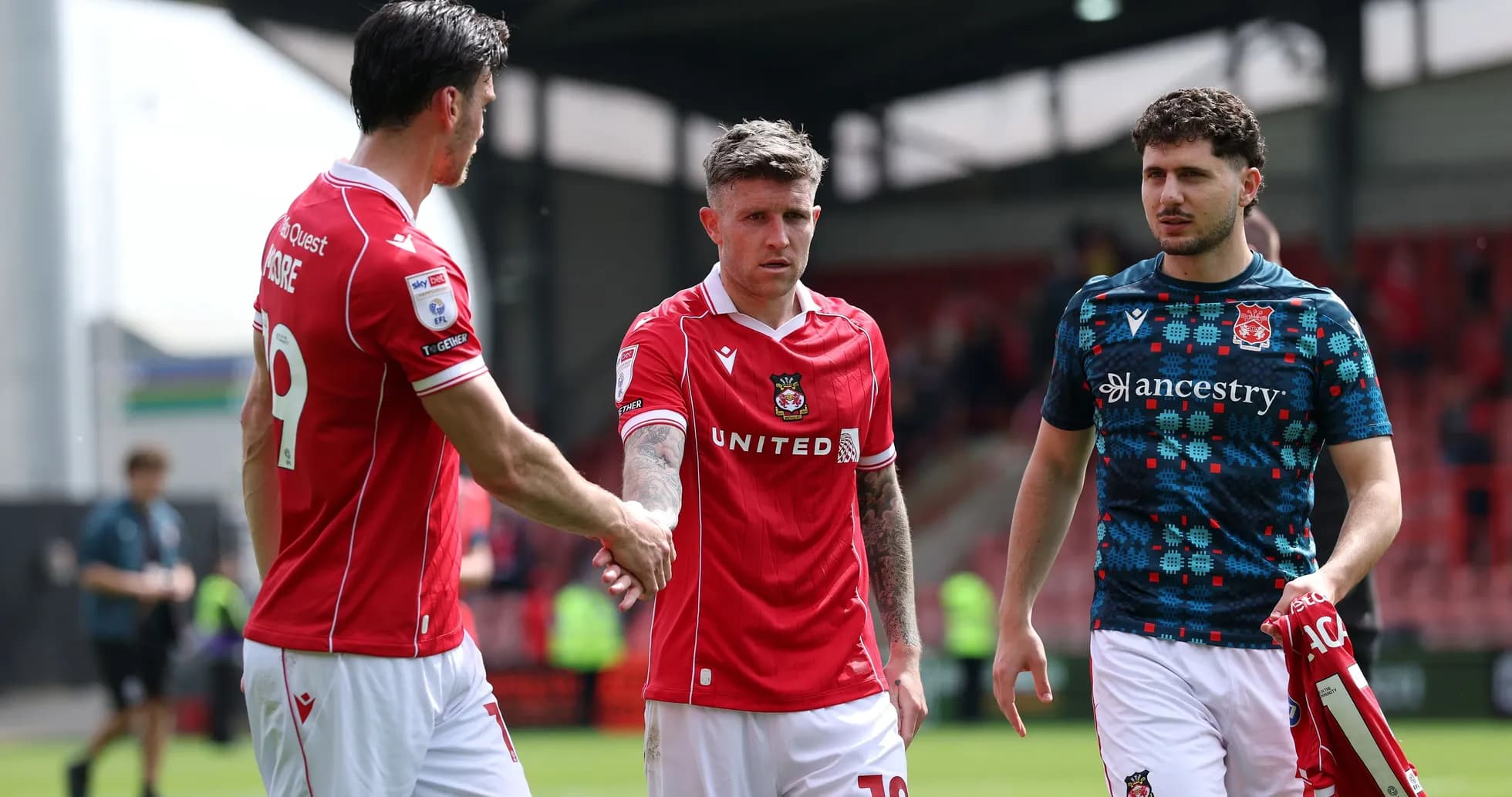Wrexham players shaking hands after a match