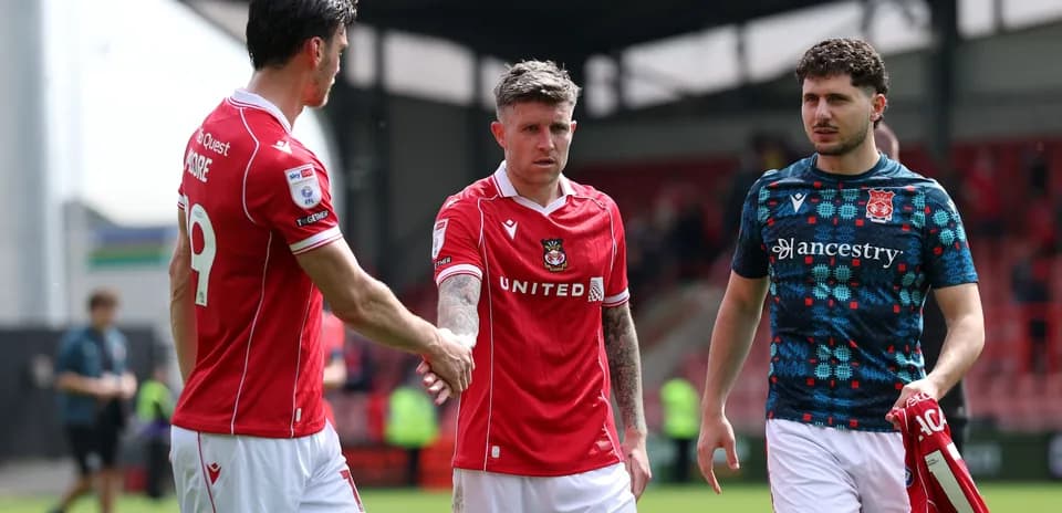 Wrexham players shaking hands after a match