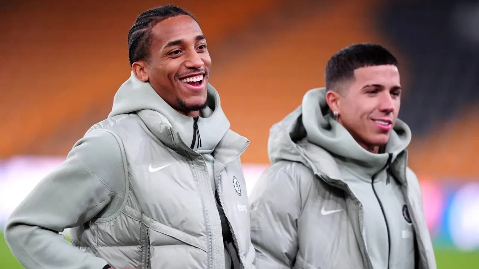 Two players smiling during warm-up session