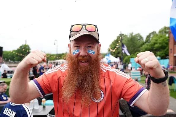 Fan celebrating with Scottish flag face paint