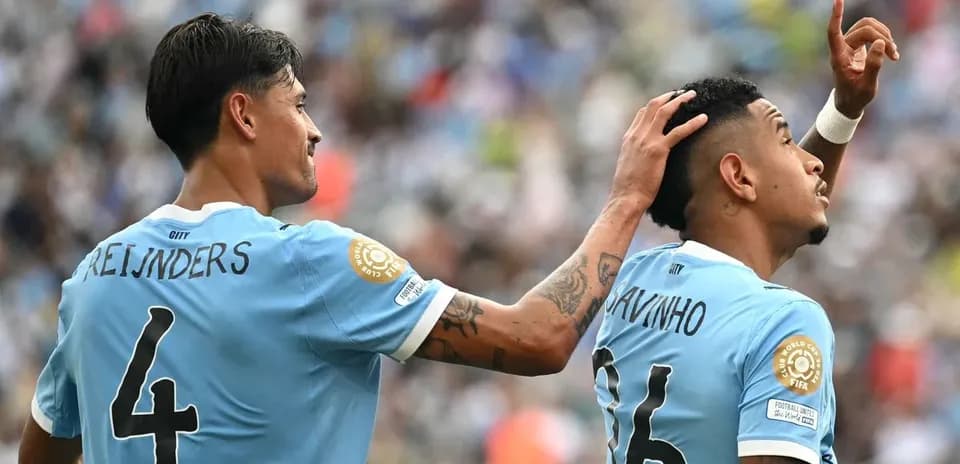 Two players celebrating a goal on the field