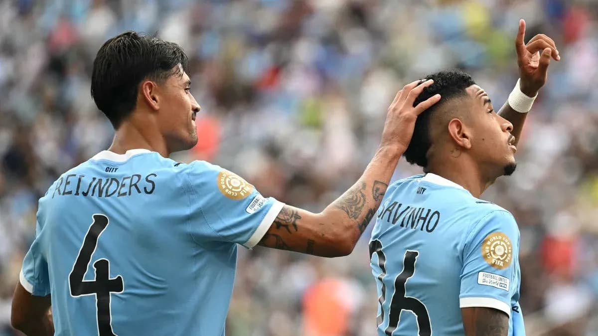 Two players celebrating a goal on the field