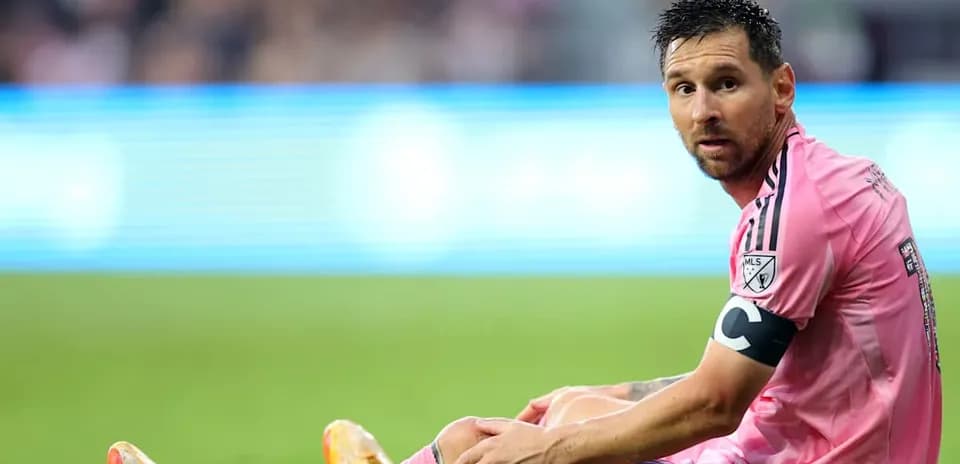Player in pink jersey sitting on field
