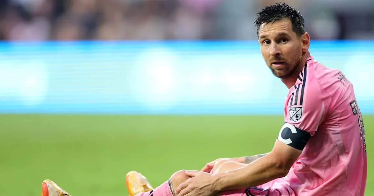 Player in pink jersey sitting on field