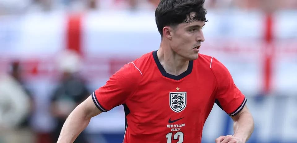 Player in red England jersey running on the field