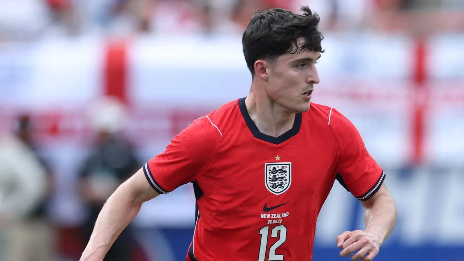 Player in red England jersey running on the field