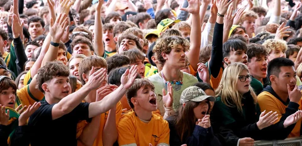 Crowd of fans cheering at sporting event