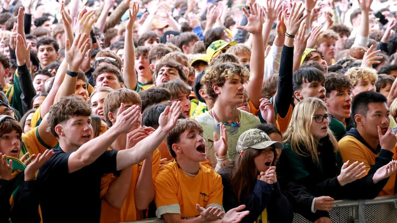 Crowd of fans cheering at sporting event