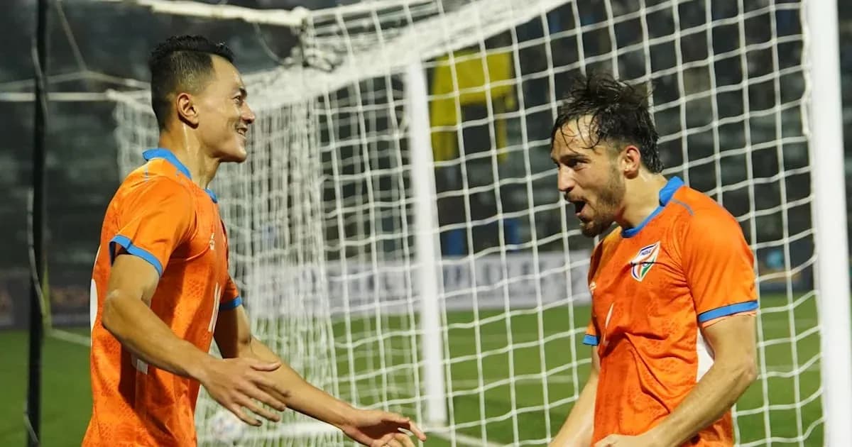 Two players celebrating a goal near the net