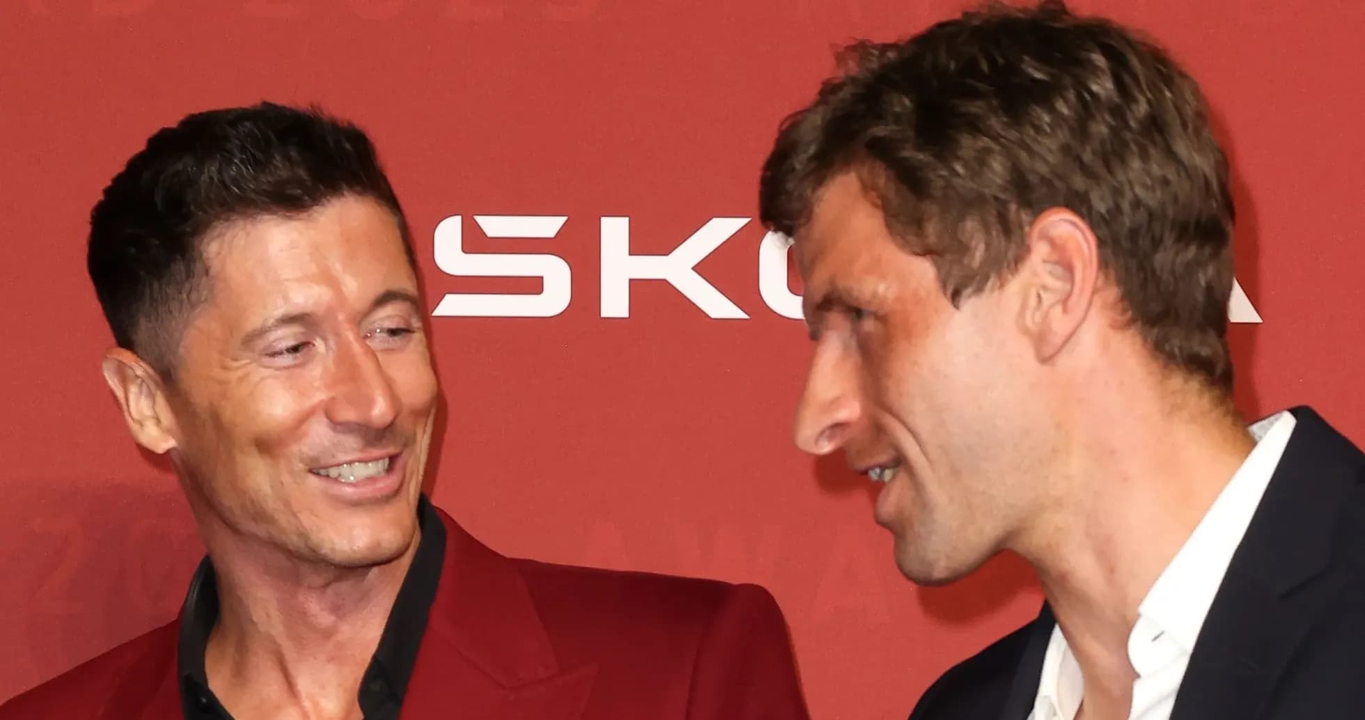 Two football players interacting at an awards event