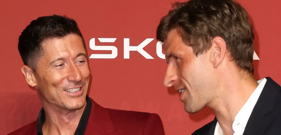 Two football players interacting at an awards event