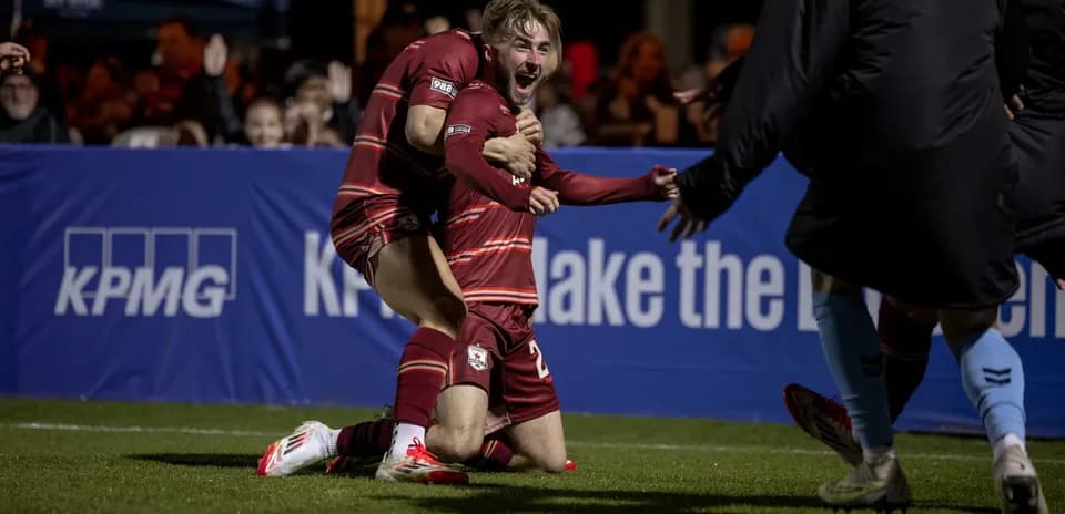 Players celebrating a goal during USL Championship match