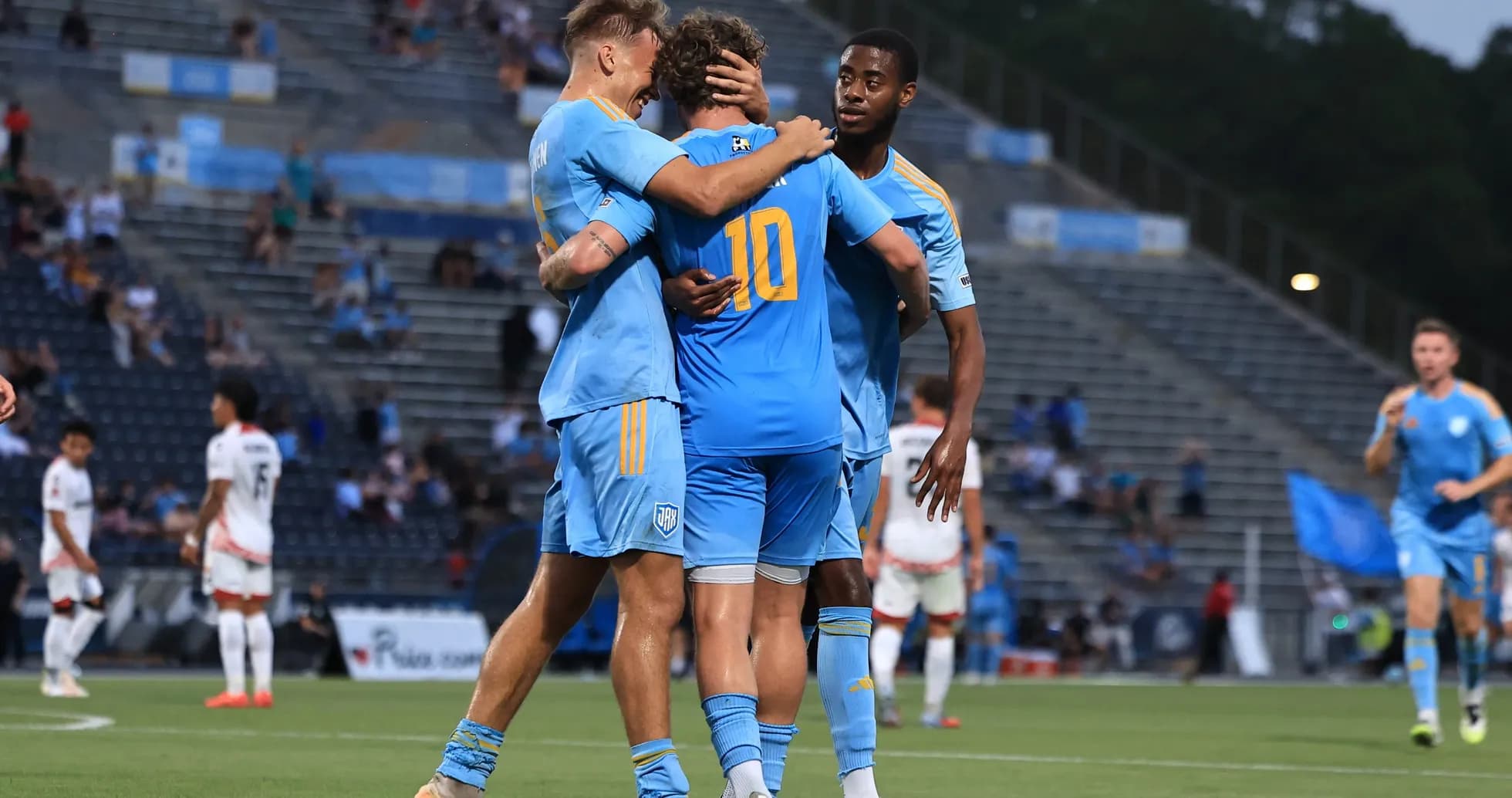 Players celebrating a goal during match