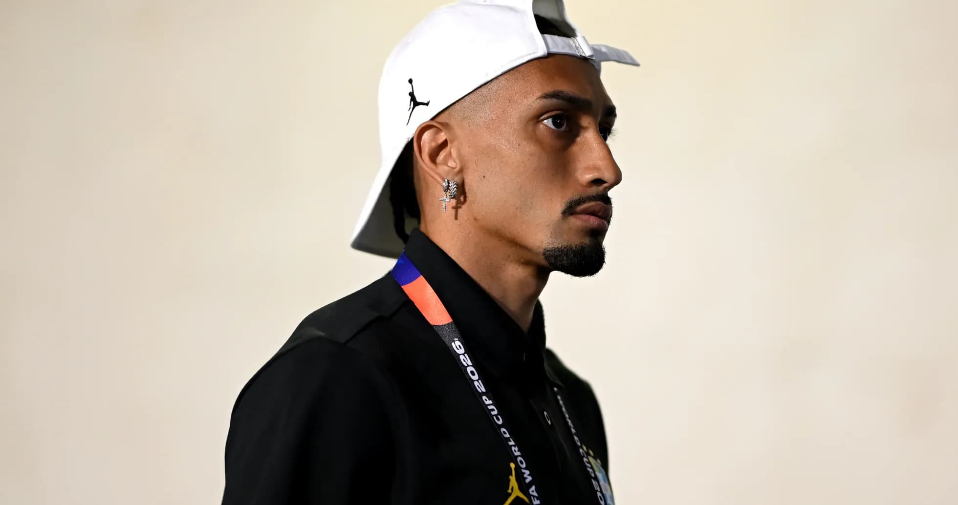 Person wearing cap and lanyard in profile view