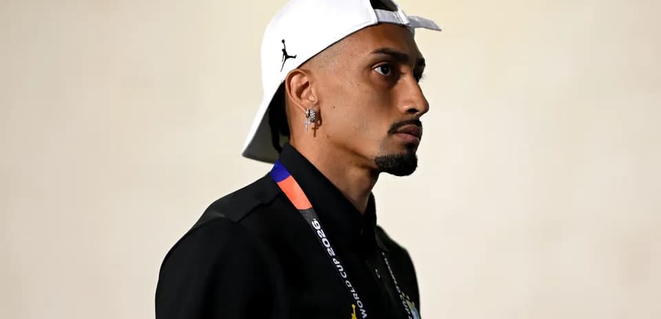 Person wearing cap and lanyard in profile view