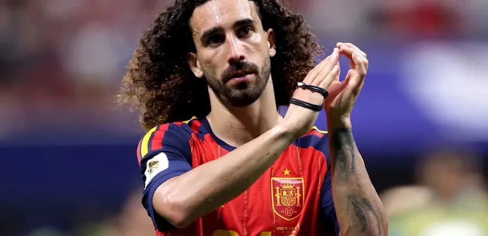 Player in Spain jersey applauding fans after match