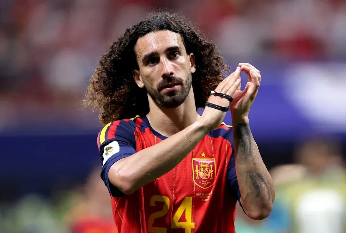 Player in Spain jersey applauding fans after match