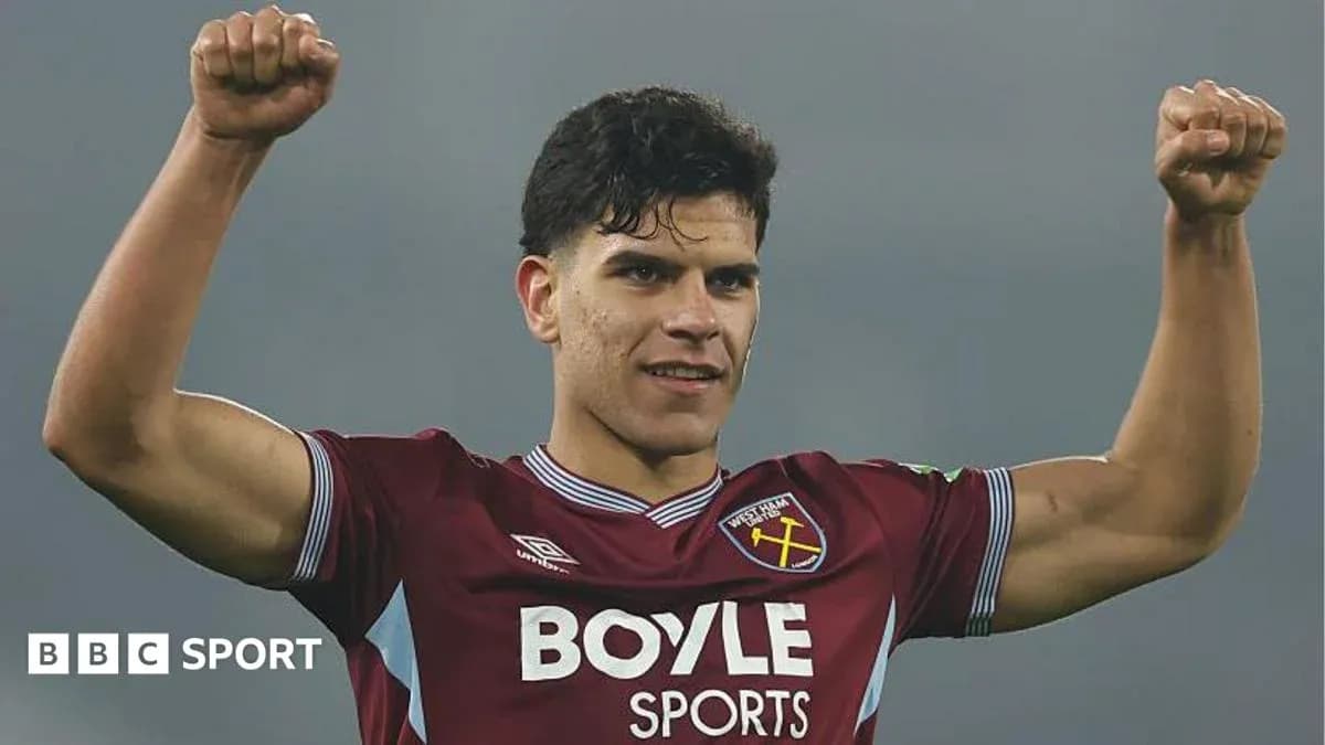 Player celebrating with raised fists in West Ham kit