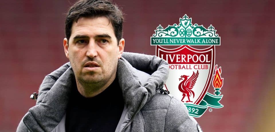 Coach in front of Liverpool FC logo
