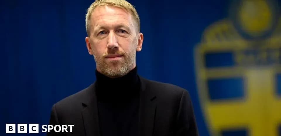 Man in black suit with turtleneck posing