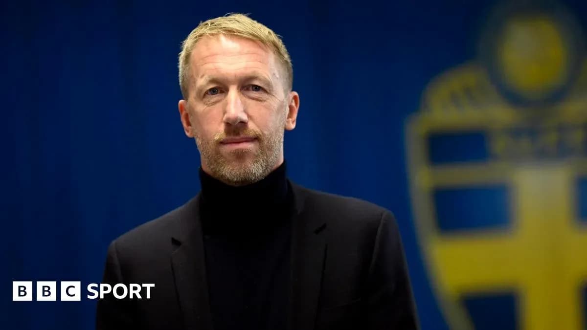 Man in black suit with turtleneck posing