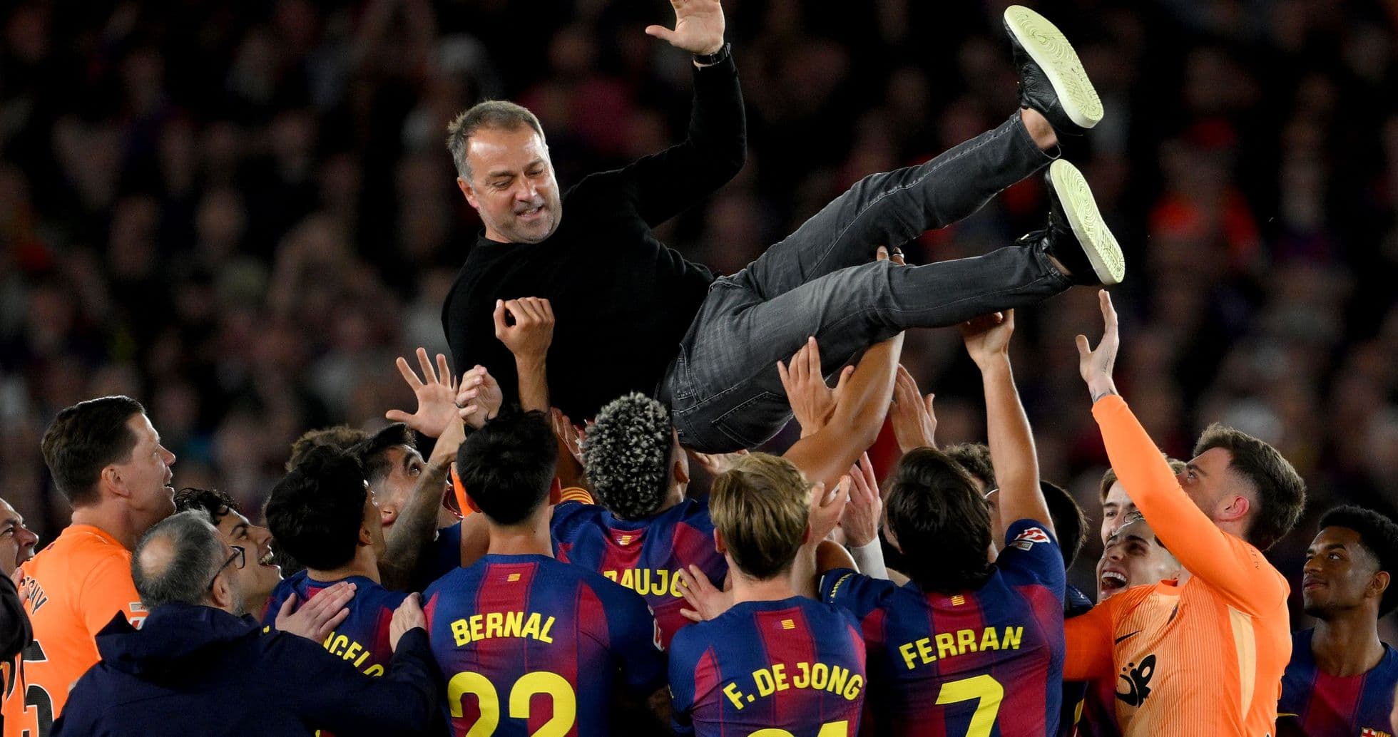 Barcelona players celebrating with their coach after victory