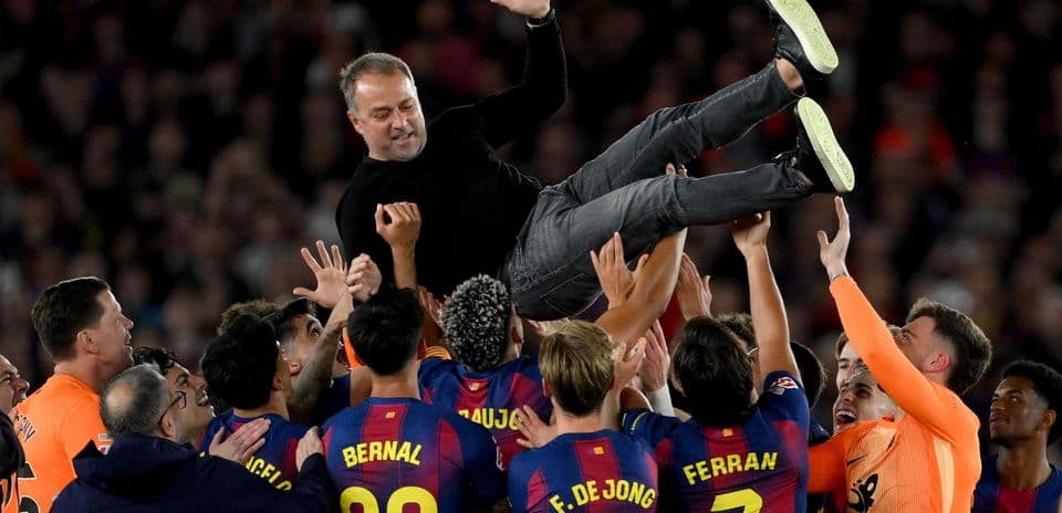 Barcelona players celebrating with their coach after victory