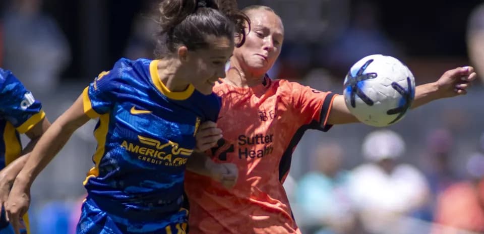 Bay FC player challenging Utah Royals goalkeeper