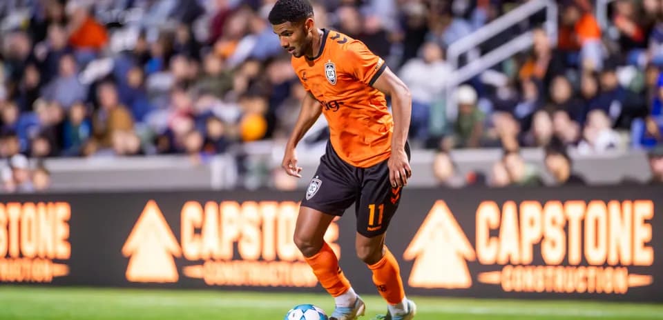 Player dribbling the ball during USL Championship match
