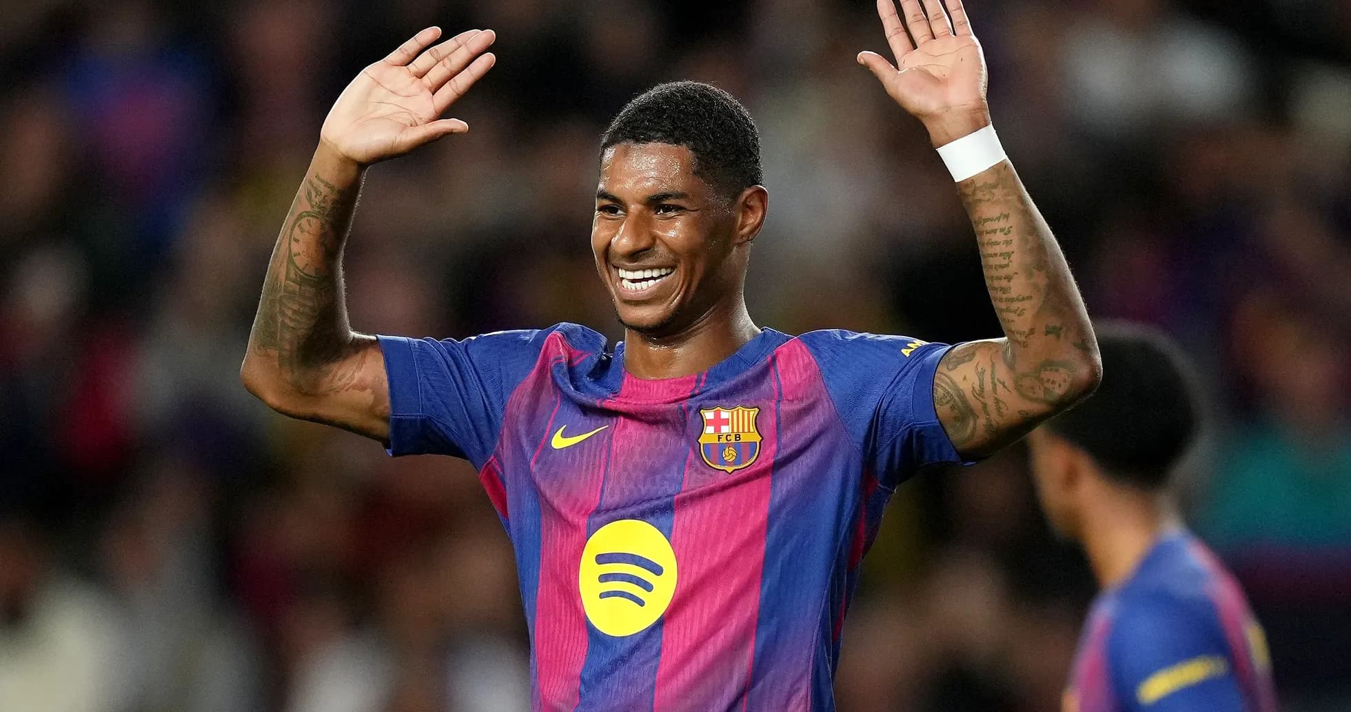 Player celebrating with raised hands on pitch