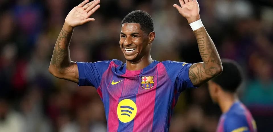 Player celebrating with raised hands on pitch
