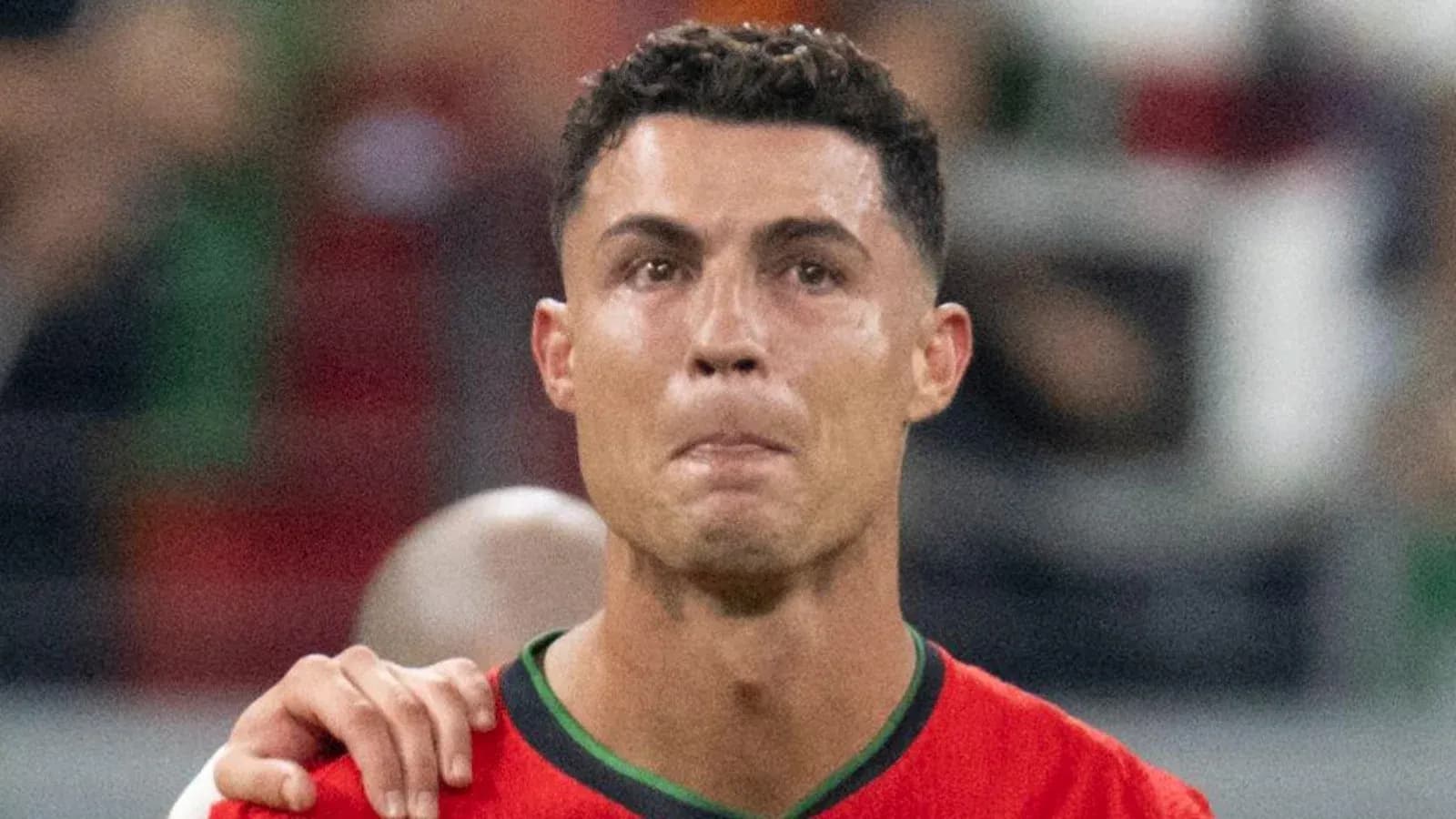 Player in red jersey during match celebration