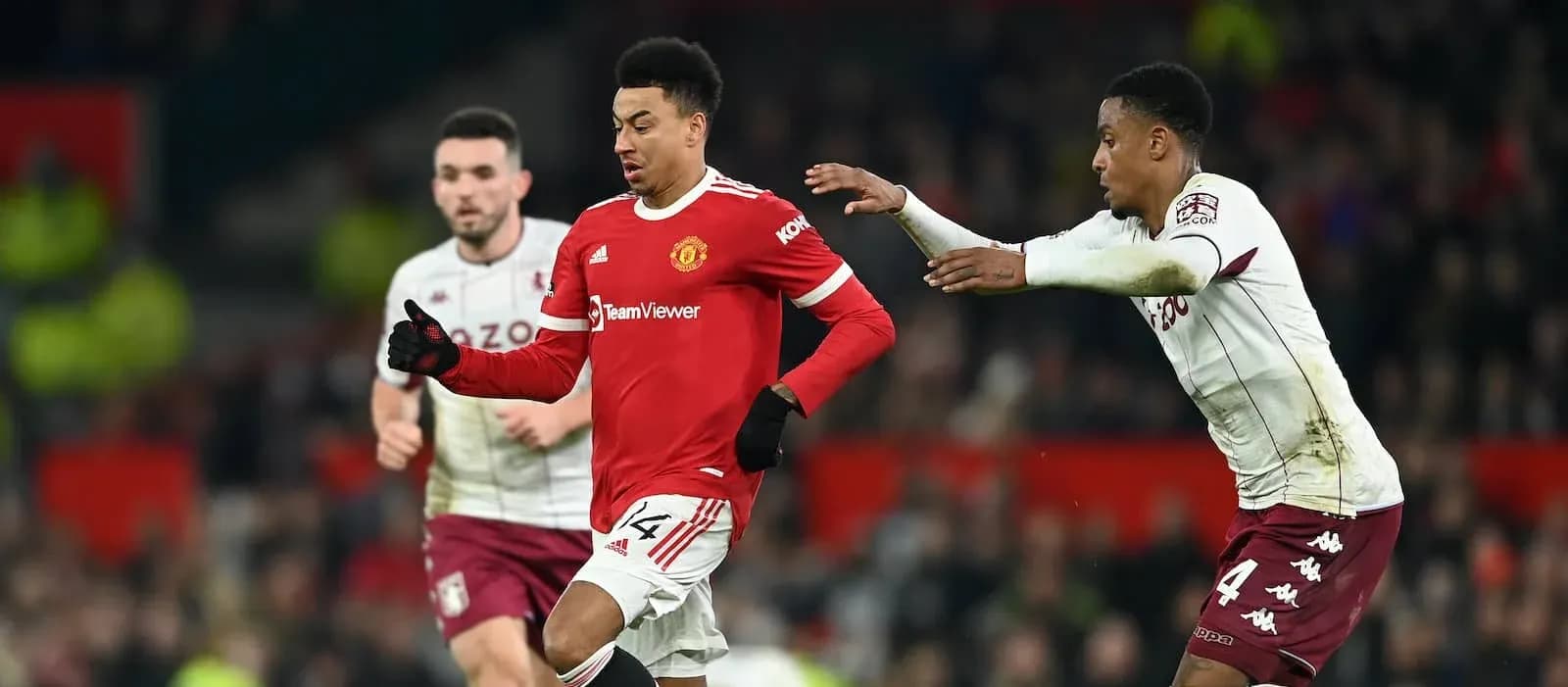 Manchester United player running with ball, Aston Villa players nearby