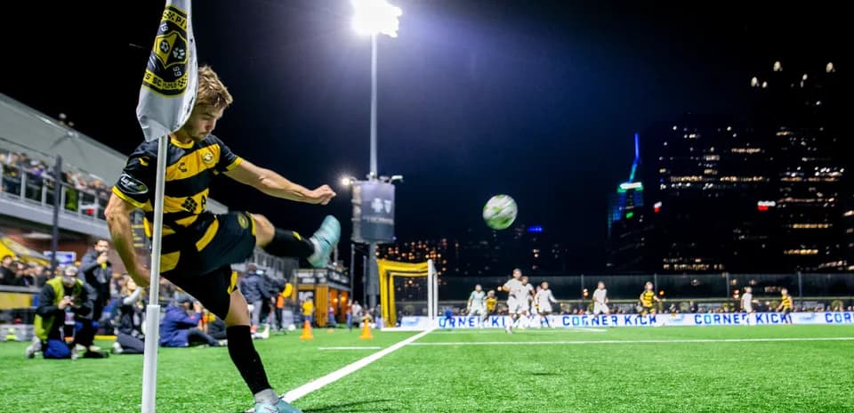 Player taking corner kick during match