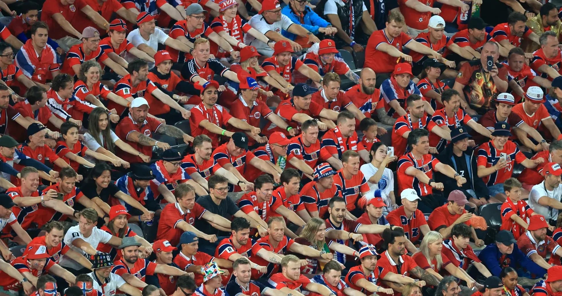 Crowd of fans in red jerseys at stadium