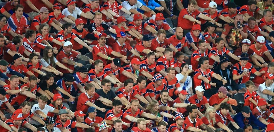 Crowd of fans in red jerseys at stadium