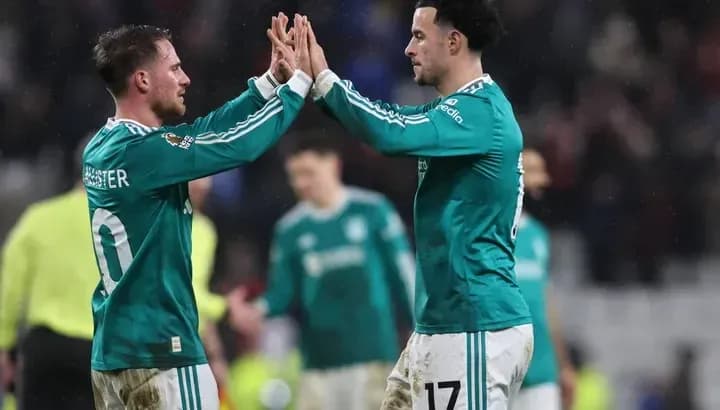 Two players celebrating a goal on the field