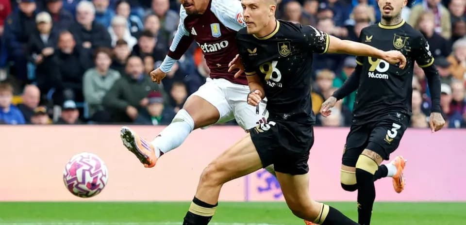 Aston Villa player striking the ball during match
