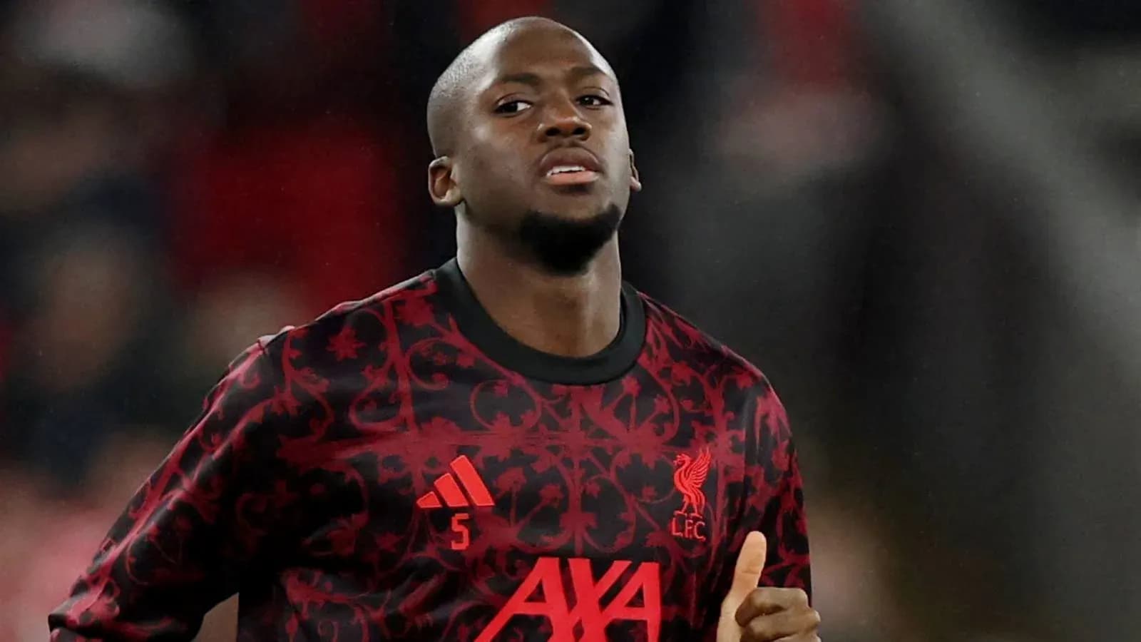 Player warming up in Liverpool kit before match