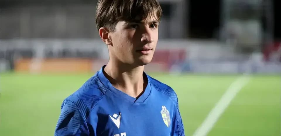 Young player in blue jersey on football field